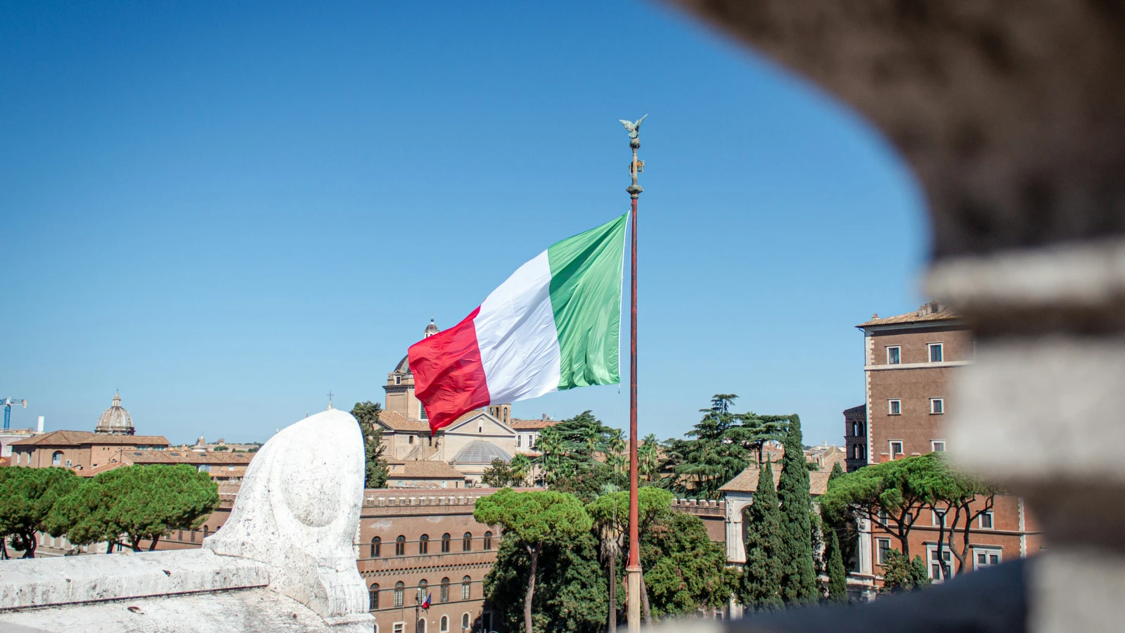 Flags near Rome's historic institutions - reference for international visitors hiring cars in Rome